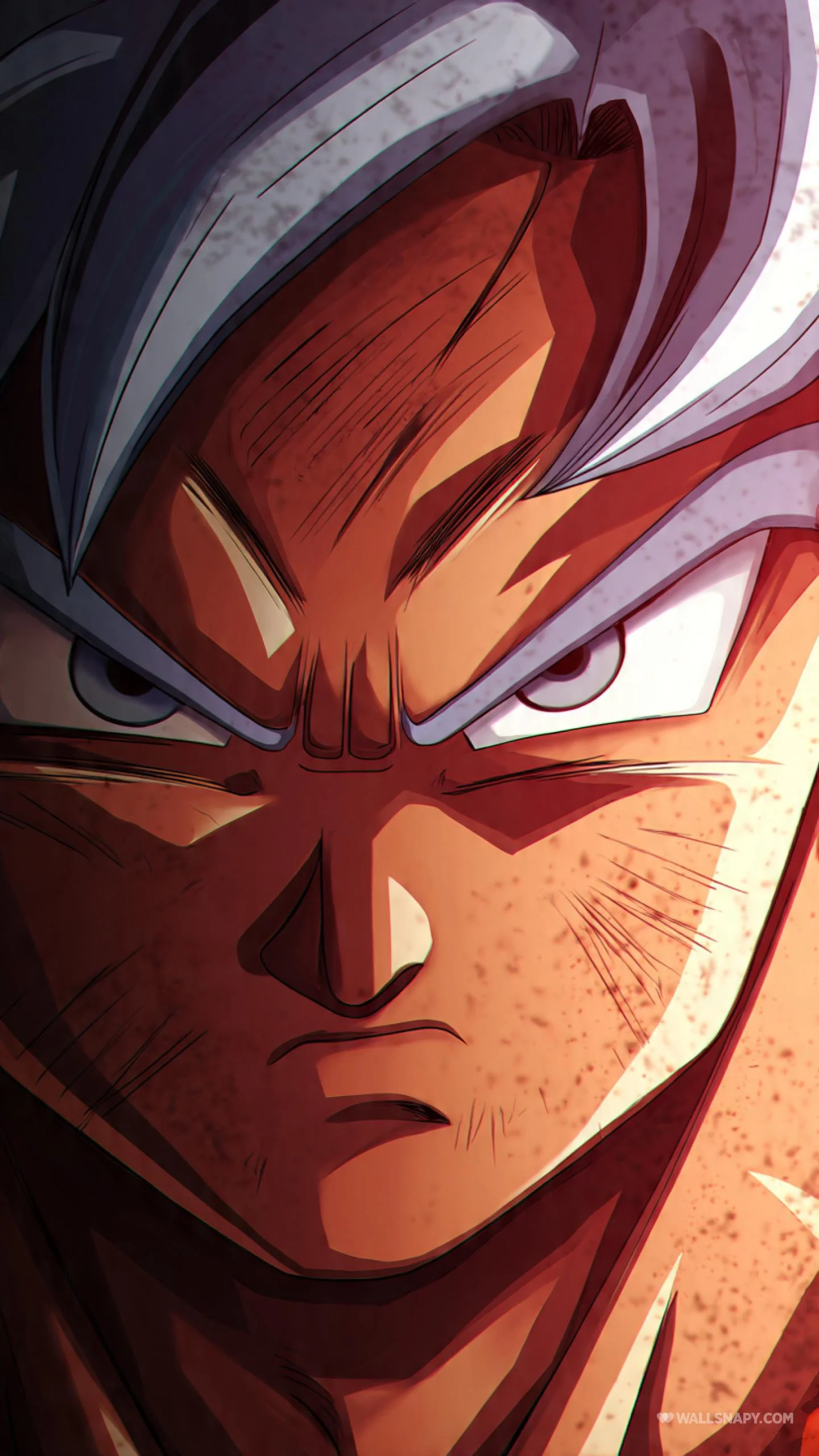 Close-up of Goku's face with an intense expression and glowing reddish-orange skin, featuring his grey hair from Ultra Instinct form.